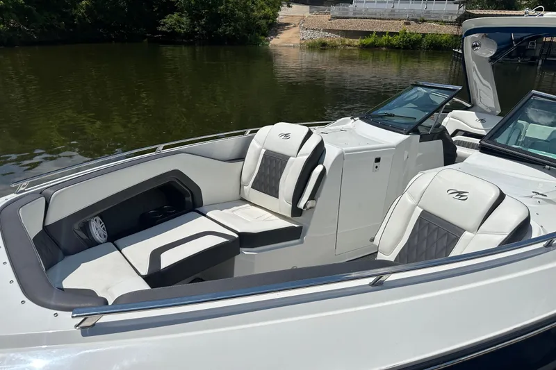 Slide: The Image of 2019 Monterey 328SS Super Sport boat with luxurious seating on a calm lake. - 18
