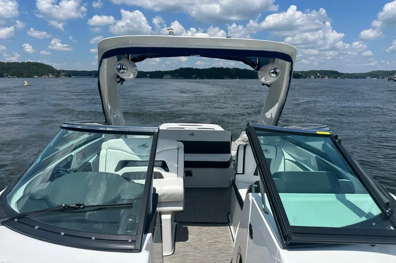 Slide: The Image of 2019 Monterey 328SS Super Sport boat on a lake under a blue sky with clouds. - 7