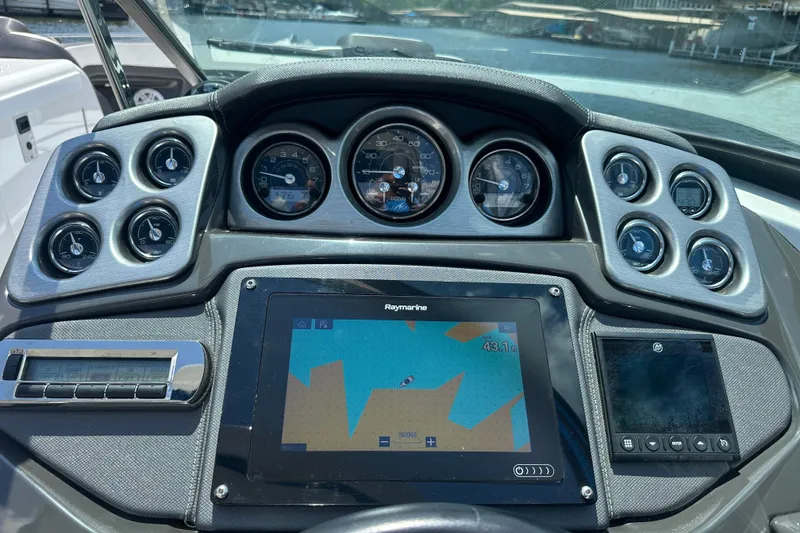 Slide: The Image of Dashboard of a 2019 Monterey 328SS Super Sport boat with navigation display. - 17