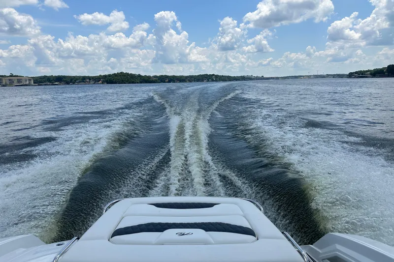 Slide: The Image of 2019 Monterey 328SS Super Sport boat cruising on a lake under a cloudy sky. - 3