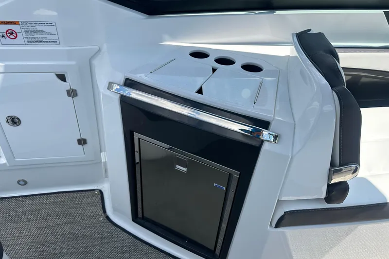 Slide: The Image of Interior of 2019 Monterey 328SS Super Sport boat with built-in cooler and seating. - 13