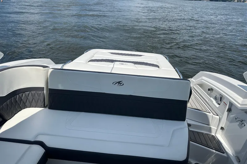 Slide: The Image of 2019 Monterey 328SS Super Sport boat interior with seating, overlooking calm waters. - 12