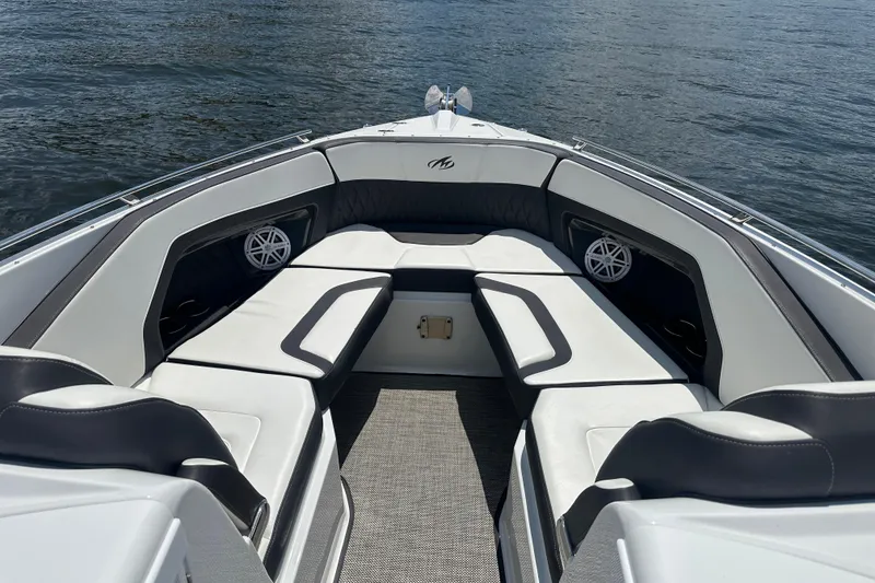 Slide: The Image of 2019 Monterey 328SS Super Sport boat interior with luxurious seating on calm water. - 4