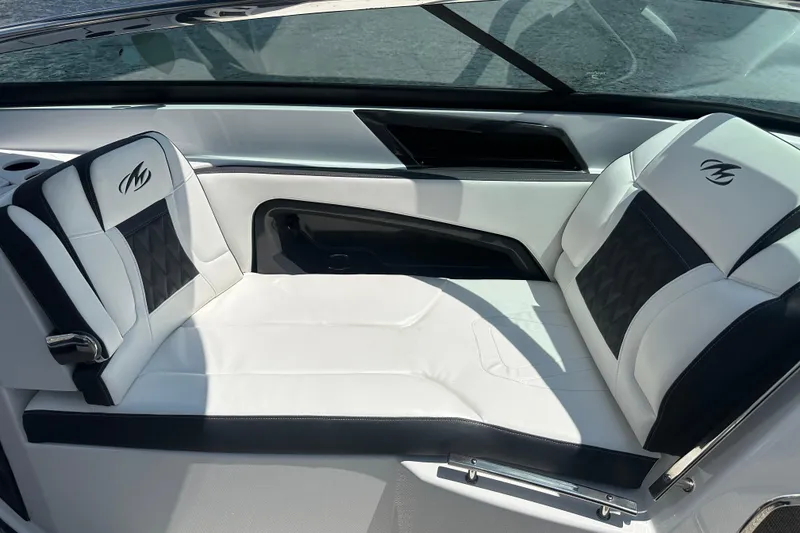 Slide: The Image of Luxurious seating on a 2019 Monterey 328SS Super Sport boat, featuring sleek white and black upholstery. - 9