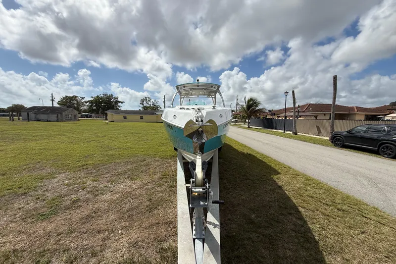 Slide: The Image of 2016 Extreme Boats XC38 on trailer, parked on grassy area under cloudy sky. - 14