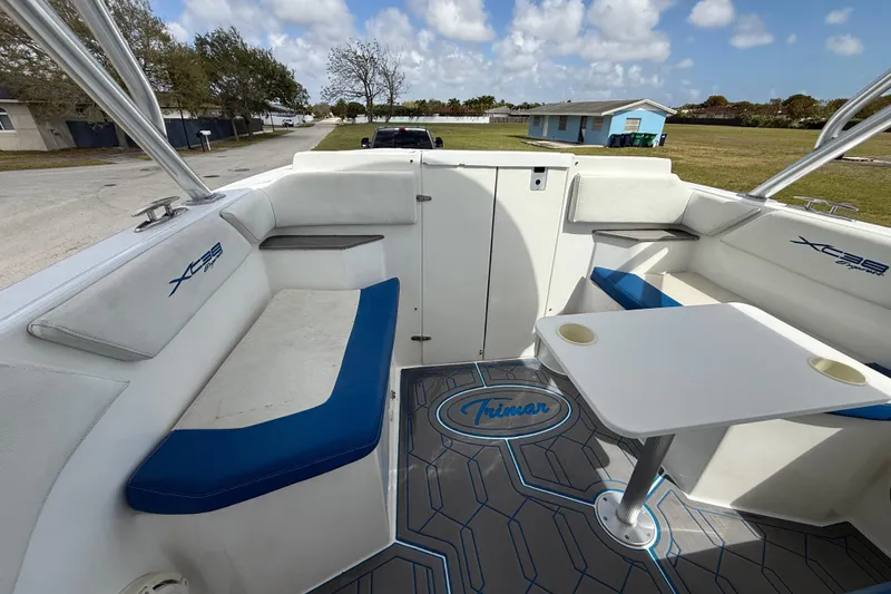 Slide: The Image of 2016 Extreme Boats XC38 interior with seating and table, featuring "Trimar" branding. - 113