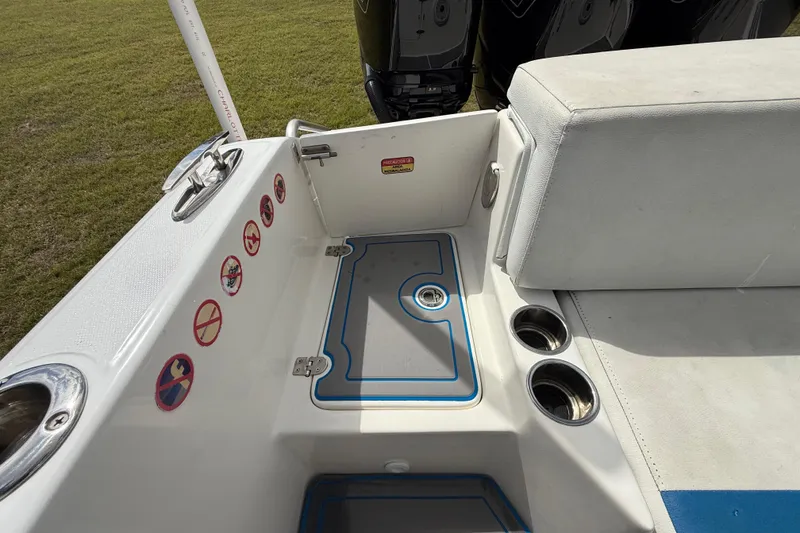 Slide: The Image of 2016 Extreme Boats XC38 interior with seating, cup holders, and safety stickers. - 96
