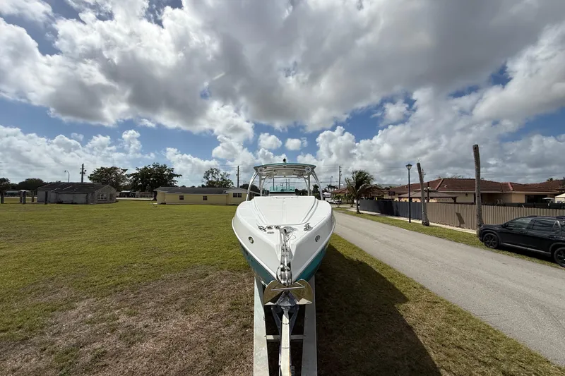 Slide: The Image of 2016 Extreme Boats XC38 on trailer, parked on grassy area under cloudy sky. - 16