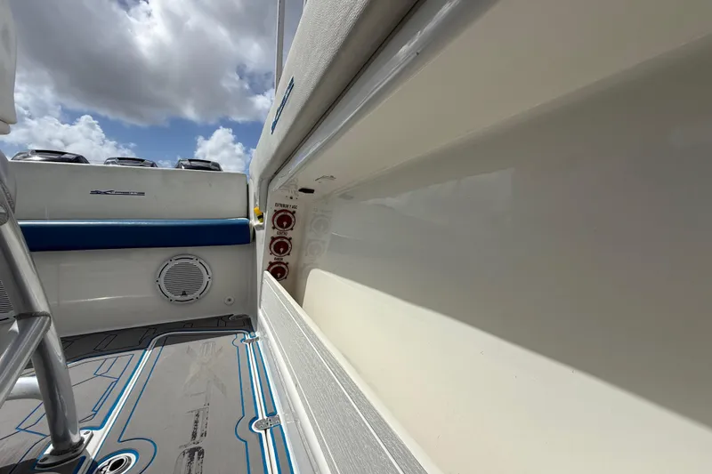 Slide: The Image of 2016 Extreme Boats XC38 interior with blue seating and control panel under cloudy sky. - 88