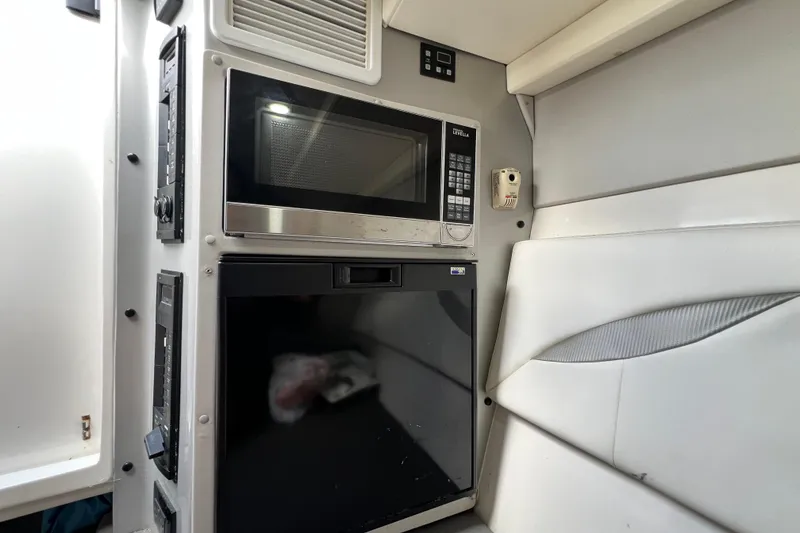 Slide: The Image of Interior of 2016 Extreme Boats XC38 featuring microwave and compact refrigerator. - 160