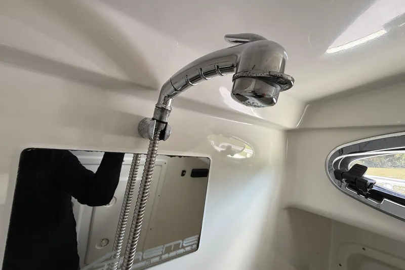 Slide: The Image of Interior of 2016 Extreme Boats XC38, featuring a chrome shower fixture and window. - 108