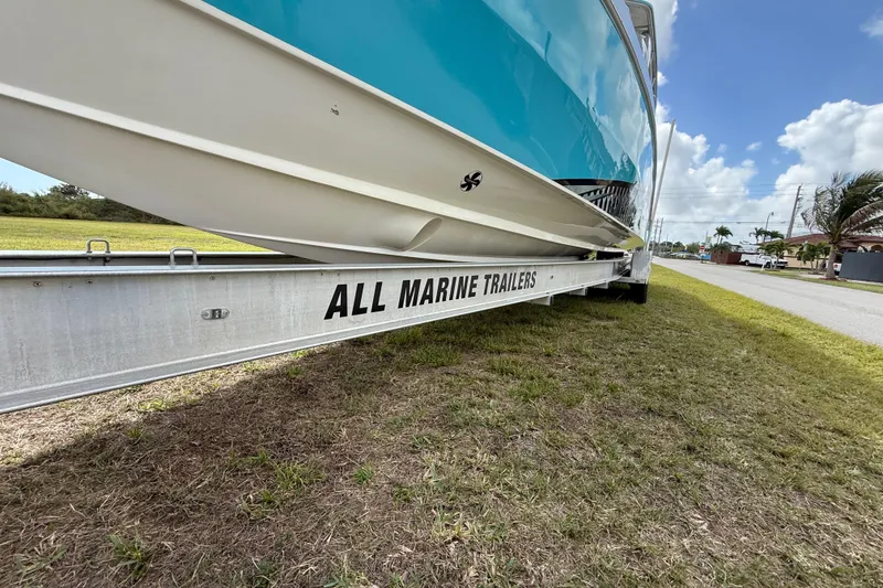 Slide: The Image of 2016 Extreme Boats XC38 on All Marine Trailers, parked on grassy roadside. - 48