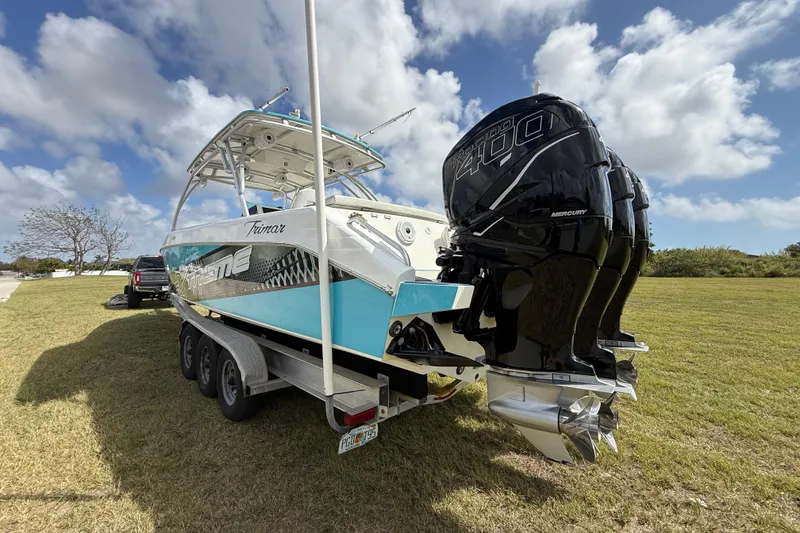 Slide: The Image of 2016 Extreme Boats XC38 on trailer, featuring powerful Mercury 400 engines, parked on grass. - 32
