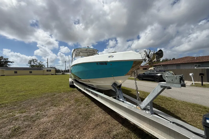 Slide: The Image of 2016 Extreme Boats XC38 on trailer under cloudy sky, parked on grass. - 4