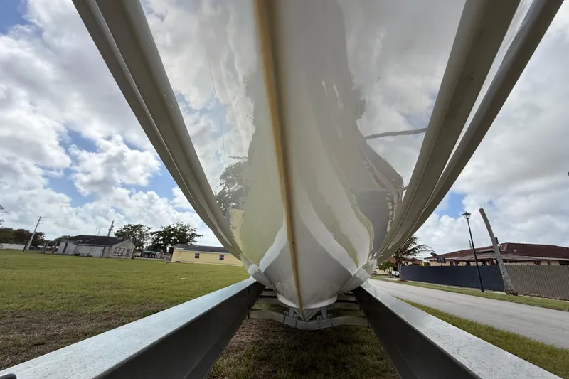 Slide: The Image of 2016 Extreme Boats XC38 hull on trailer, under cloudy sky. - 55
