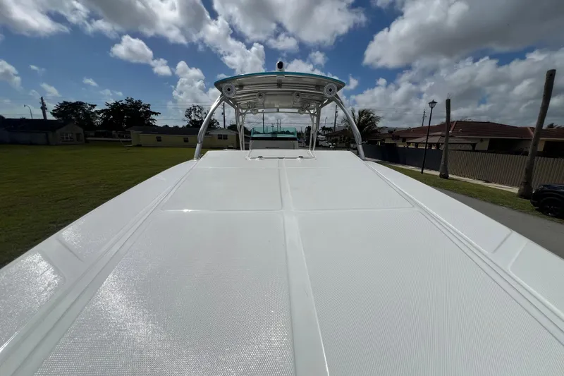 Slide: The Image of 2016 Extreme Boats XC38 with sleek white deck under a partly cloudy sky. - 179