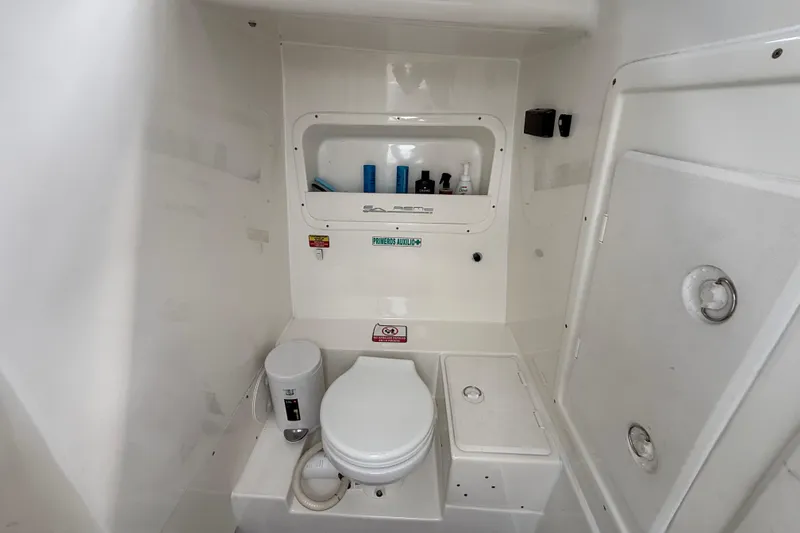 Slide: The Image of Bathroom interior of 2016 Extreme Boats XC38, featuring a compact toilet and storage. - 106