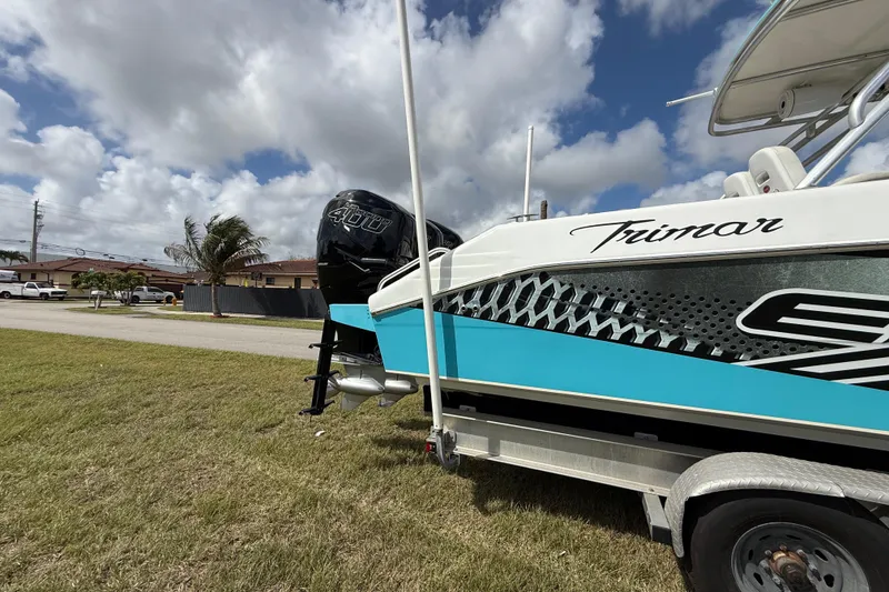 Slide: The Image of 2016 Extreme Boats XC38 on trailer, featuring a powerful 400HP engine, under a partly cloudy sky. - 25