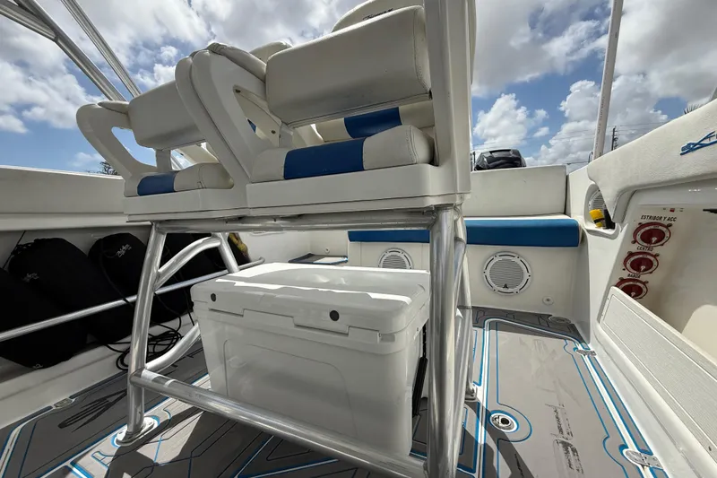 Slide: The Image of Interior of 2016 Extreme Boats XC38, featuring seating and storage under a sunny sky. - 91