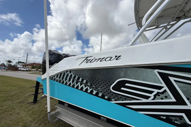 Slide: The Image of 2016 Extreme Boats XC38 with "Trimar" branding, parked outdoors under a cloudy sky. - 73