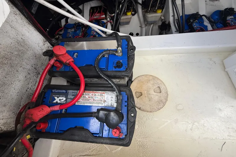 Slide: The Image of Battery compartment of a 2016 Extreme Boats XC38, featuring dual blue marine batteries. - 135