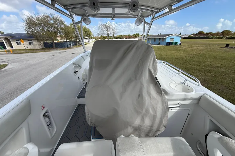 Slide: The Image of 2016 Extreme Boats XC38 interior with covered helm, showcasing spacious deck and seating. - 9