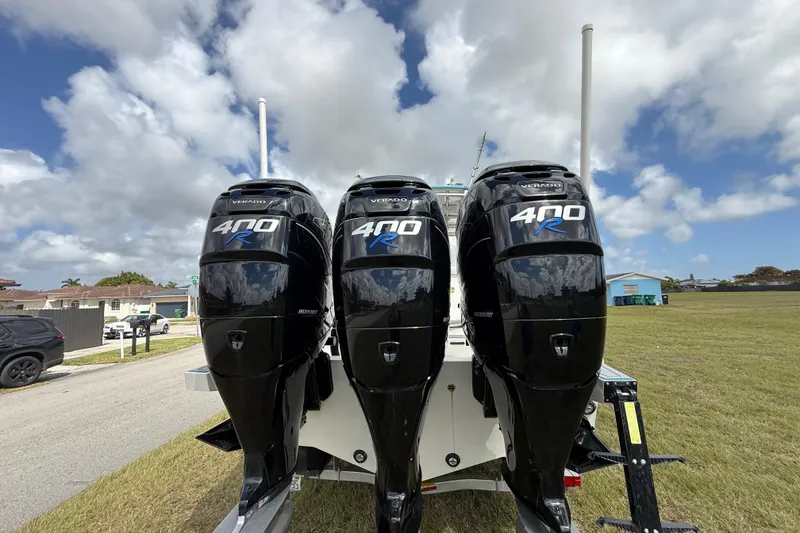 Slide: The Image of Triple Mercury 400R outboard engines on a 2016 Extreme Boats XC38 under a cloudy sky. - 71