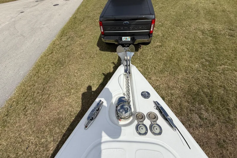 Slide: The Image of Bow of 2016 Extreme Boats XC38 near a parked truck on grass. - 145