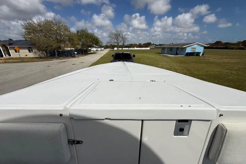 Slide: The Image of 2016 Extreme Boats XC38 on trailer, parked in suburban neighborhood under cloudy sky. - 142