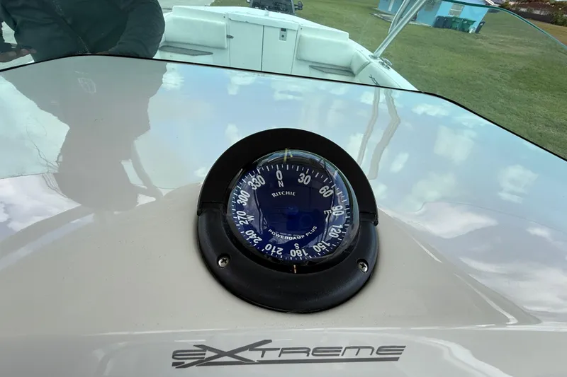 Slide: The Image of Compass on 2016 Extreme Boats XC38 dashboard, reflecting sky and surroundings. - 116