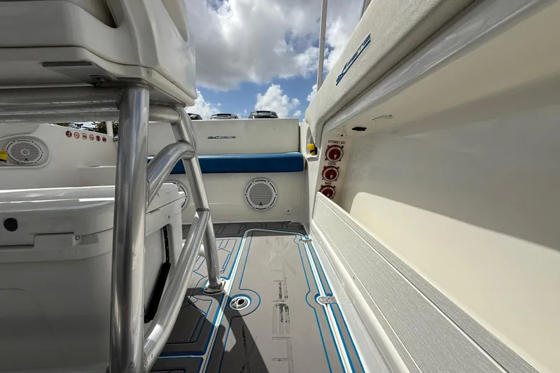 Slide: The Image of 2016 Extreme Boats XC38 interior with seating, storage, and control panel under a cloudy sky. - 89