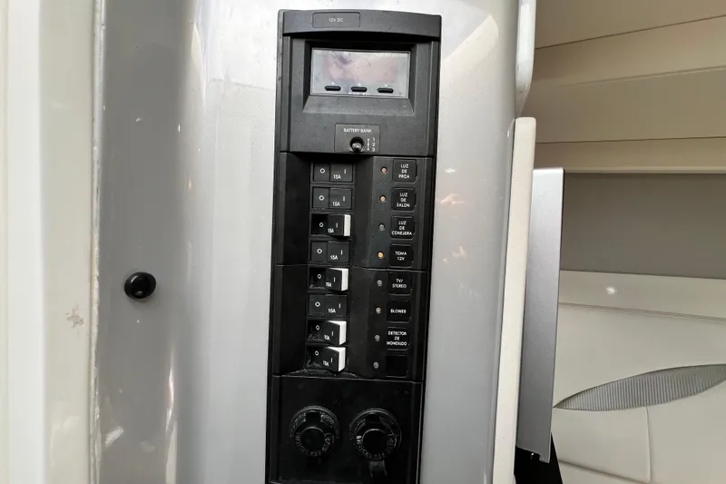 Slide: The Image of Control panel of a 2016 Extreme Boats XC38, featuring switches and dials. - 164
