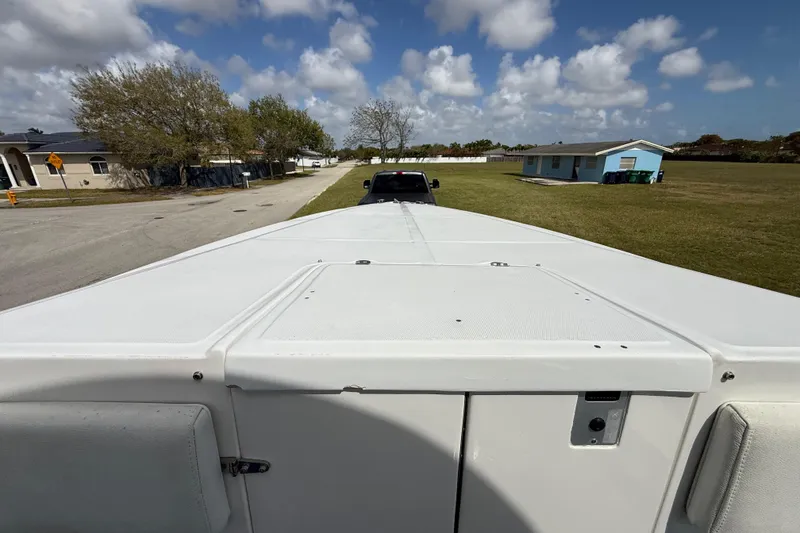 Slide: The Image of 2016 Extreme Boats XC38 on trailer, parked in residential area under cloudy sky. - 143