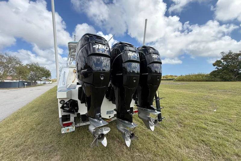 Slide: The Image of 2016 Extreme Boats XC38 with triple Mercury 400R outboard engines on grassy area. - 30