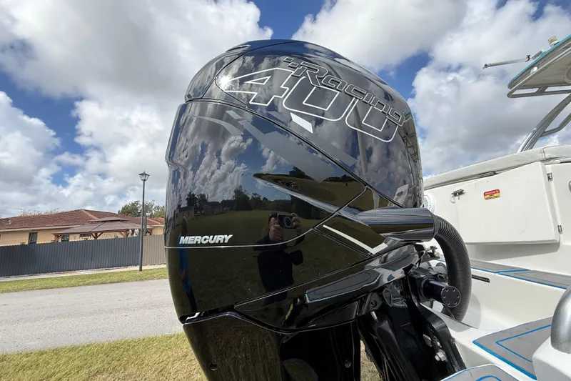 Slide: The Image of Mercury Racing 400 outboard engine on 2016 Extreme Boats XC38 under a cloudy sky. - 63