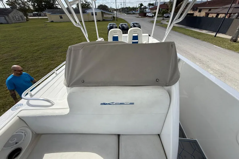 Slide: The Image of 2016 Extreme Boats XC38 with covered seating and dual engines, parked on grass. - 10