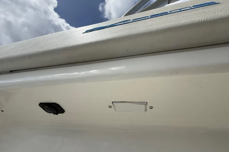 Slide: The Image of 2016 Extreme Boats XC38 exterior detail with blue logo under cloudy sky. - 134