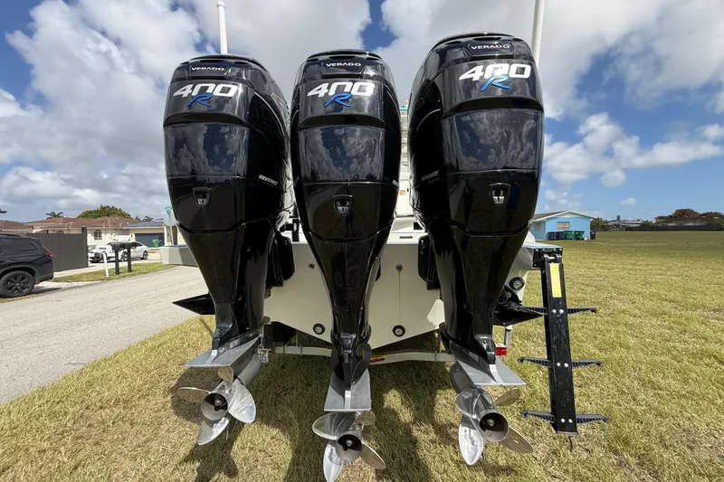 Slide: The Image of Triple Mercury Verado 400R engines on a 2016 Extreme Boats XC38, parked on grass. - 61
