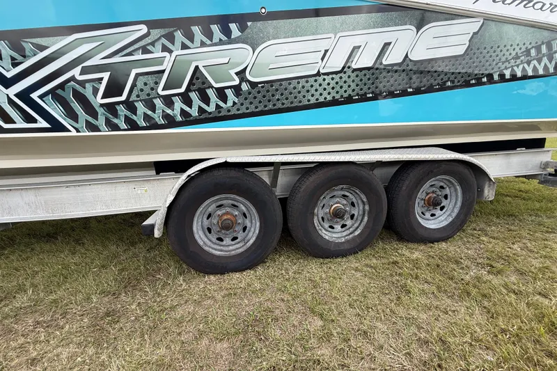 Slide: The Image of Trailer with three wheels for 2016 Extreme Boats XC38 on grass. - 49