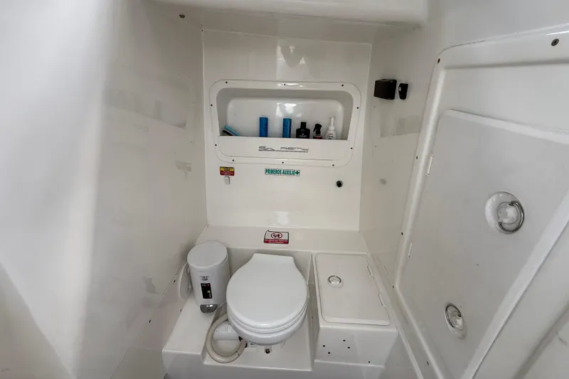 Slide: The Image of Compact bathroom in 2016 Extreme Boats XC38, featuring toilet and storage compartments. - 105