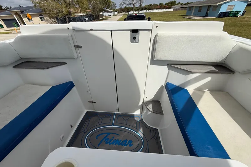 Slide: The Image of 2016 Extreme Boats XC38 interior with blue and white seating, featuring "Trimar" logo on the floor. - 141