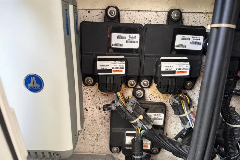 Slide: The Image of Electrical components and wiring inside a 2016 Extreme Boats XC38, featuring JL Audio equipment. - 126