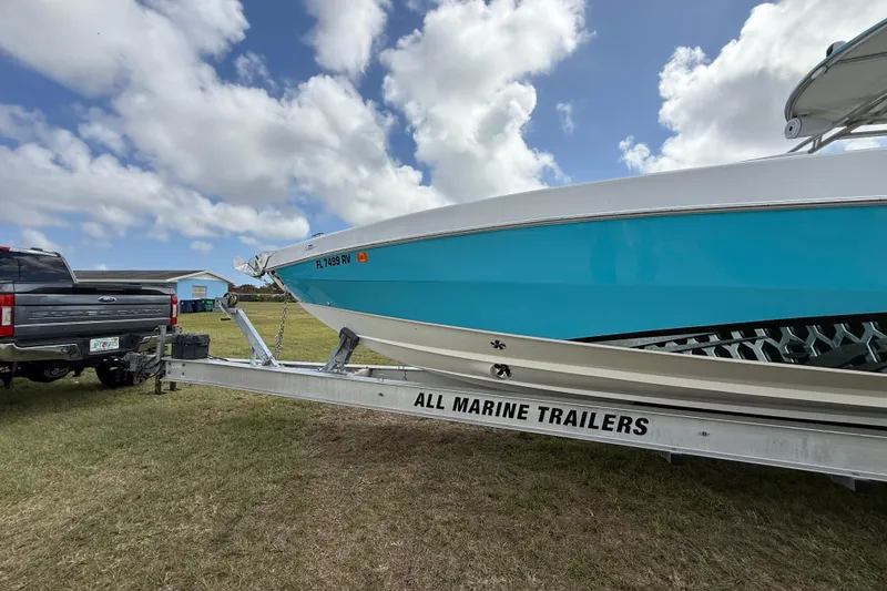 Slide: The Image of 2016 Extreme Boats XC38 on trailer, attached to a truck, under a cloudy sky. - 40