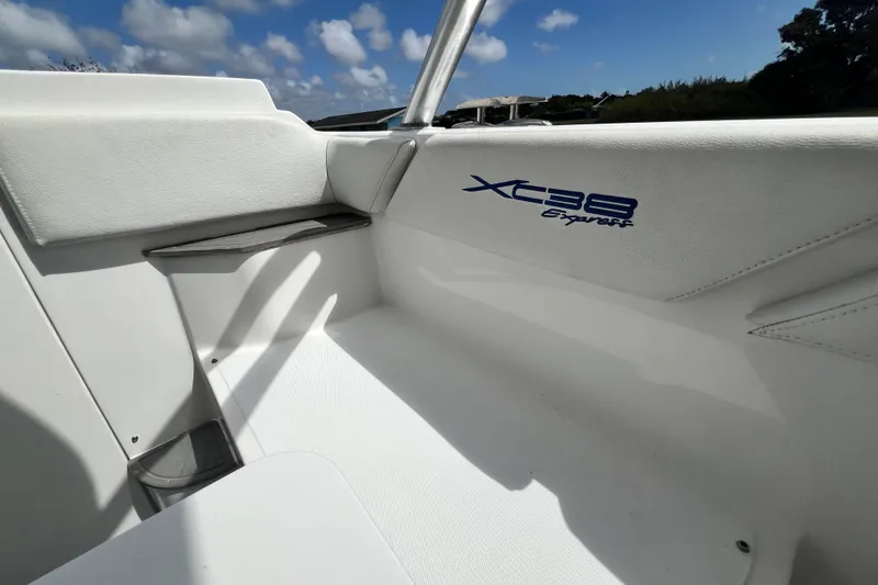 Slide: The Image of Interior view of 2016 Extreme Boats XC38, showcasing sleek white seating and logo. - 182