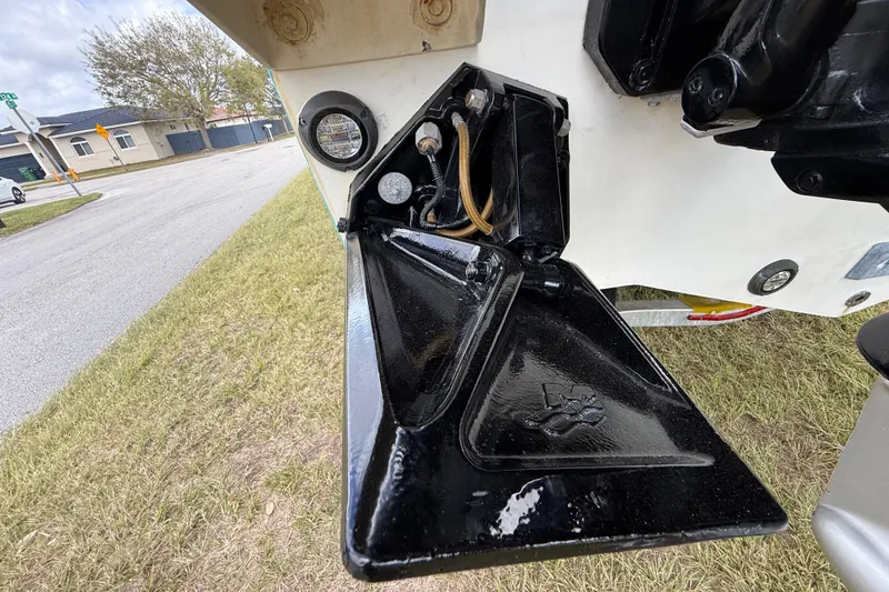 Slide: The Image of Close-up of 2016 Extreme Boats XC38 trim tab mechanism on grass. - 50