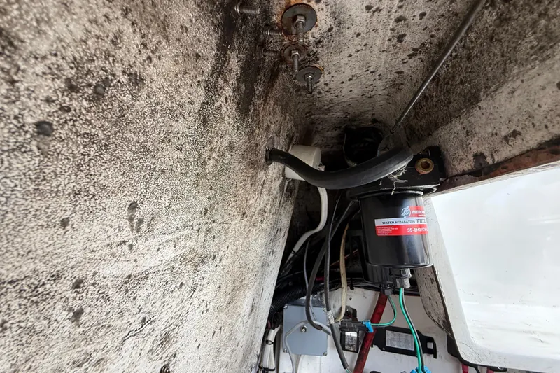 Slide: The Image of Interior view of a 2016 Extreme Boats XC38 engine compartment with fuel filter and wiring. - 130