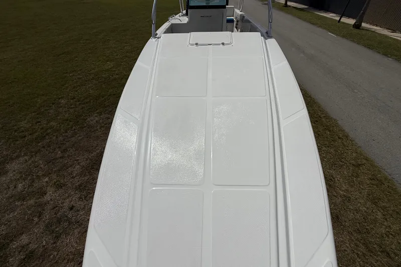 Slide: The Image of 2016 Extreme Boats XC38 deck view, showcasing sleek design on grassy terrain. - 147