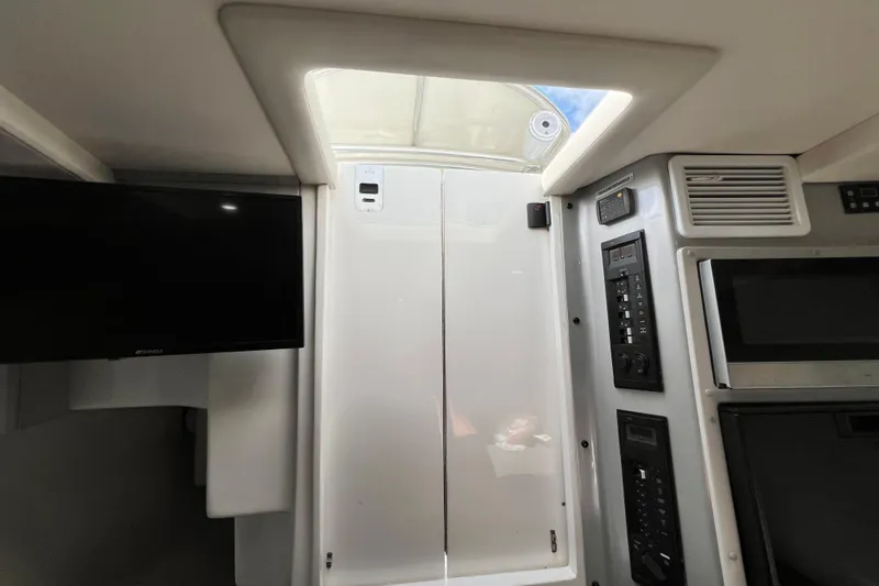 Slide: The Image of Interior view of 2016 Extreme Boats XC38, featuring control panels and a television. - 161