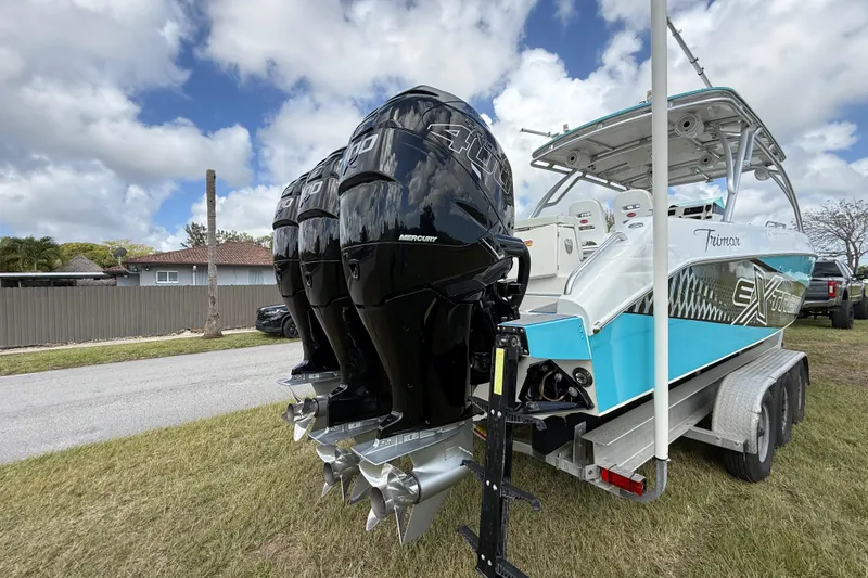 Slide: The Image of 2016 Extreme Boats XC38 with triple Mercury outboards on a trailer, under a cloudy sky. - 27