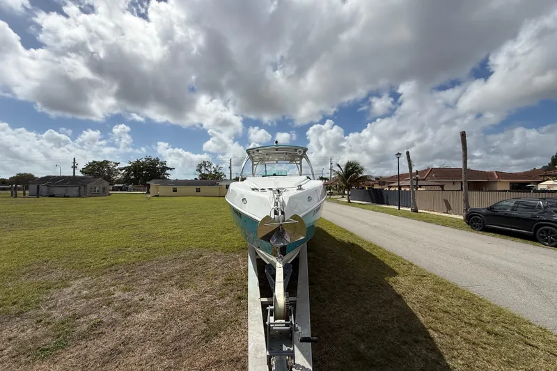 Slide: The Image of 2016 Extreme Boats XC38 on trailer under cloudy sky, parked on grassy area. - 15